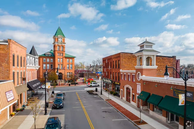 Aerial view of the village center in Lancaster, NY, with the Lancaster Opera House clock tower and brick storefronts along the street