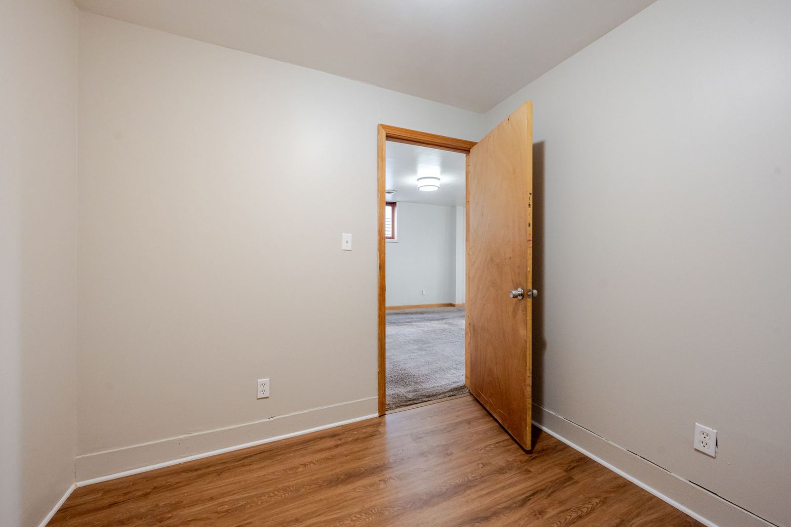 Bedroom with wood-look flooring, toward the doorway