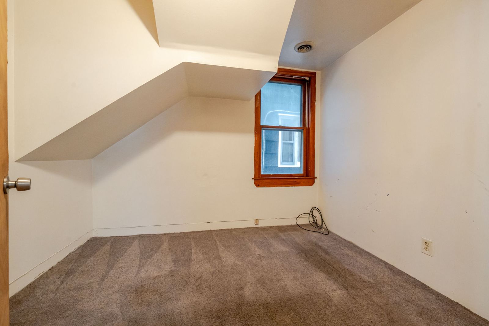 Bedroom with a sloped ceiling